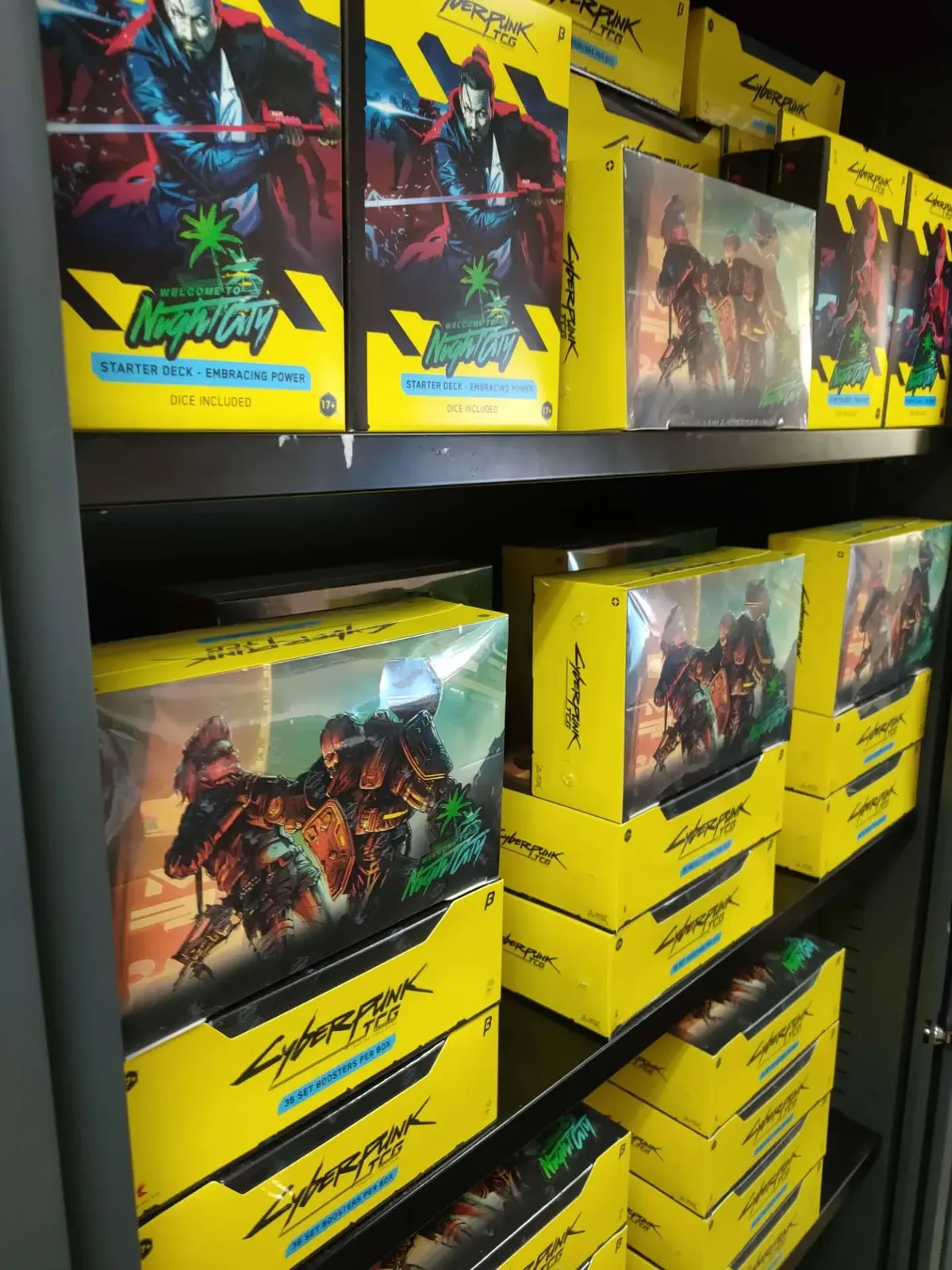 Shelves packed with Cyberpunk TCG booster boxes at Ravenspire Games